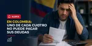 Homem preocupado avaliando documentos financeiros com bandeira da Colômbia