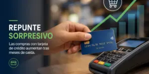 Mão segurando cartão de crédito sobre terminal com gráficos de tendência